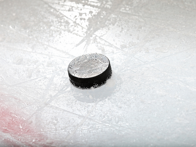 Hockey fan makes difficult shot, wins $100K
