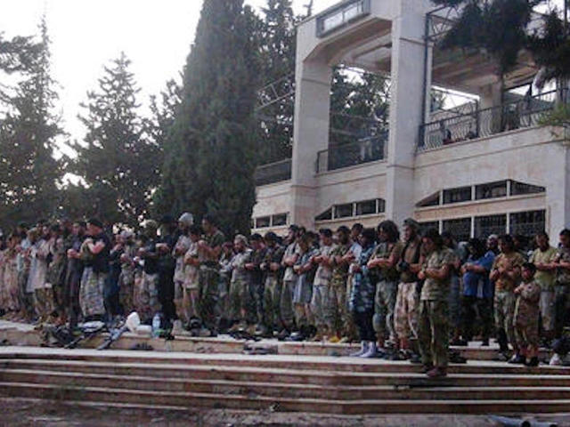 Syria activists say airstrikes on IS-held Raqqa kill 18