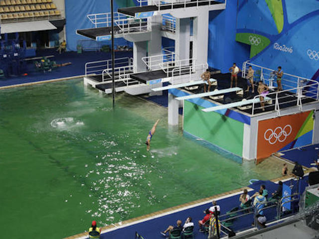 Olympic pool with green water to be drained, refilled