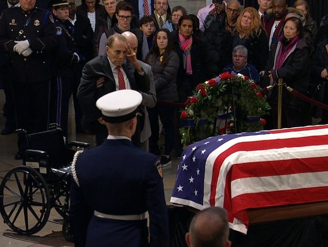 Watch: Bob Dole helped out of his wheelchair to salute George H.W. Bush